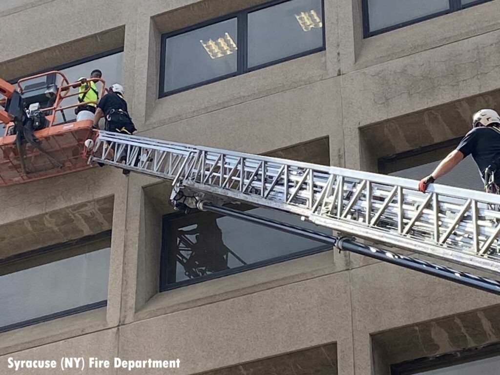 Syracuse NY firefighters rescue window washers using aerial ladder