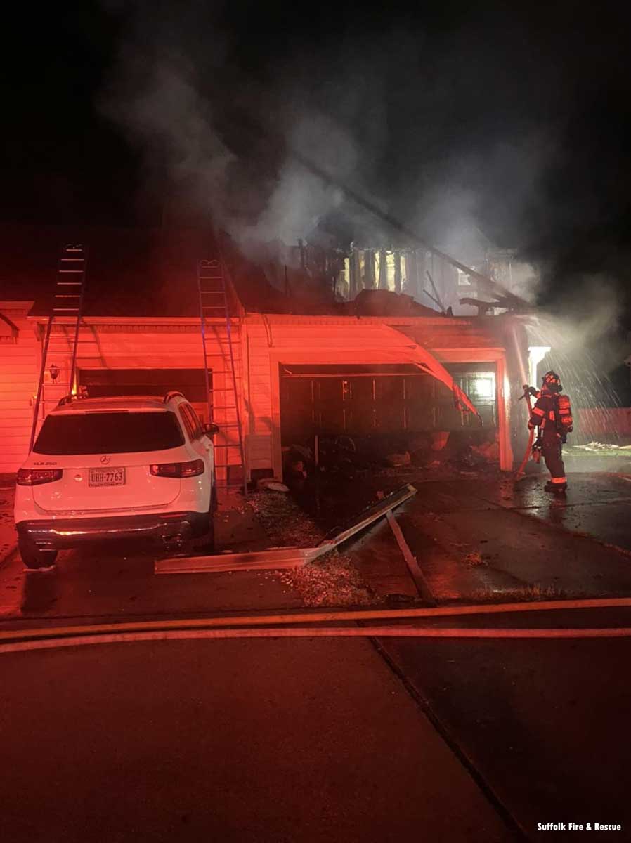 Firefighter puts water on duplex fire in Suffolk