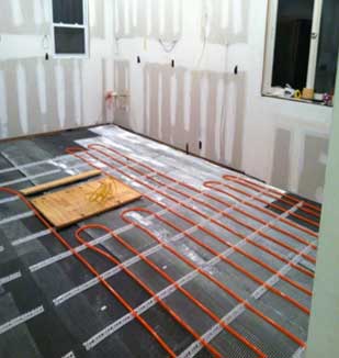 Installation of heating coils on the subfloor