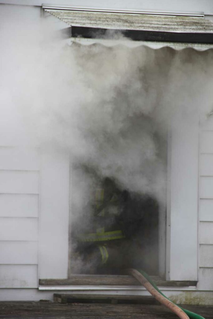 Smoke condition at window with firefighter