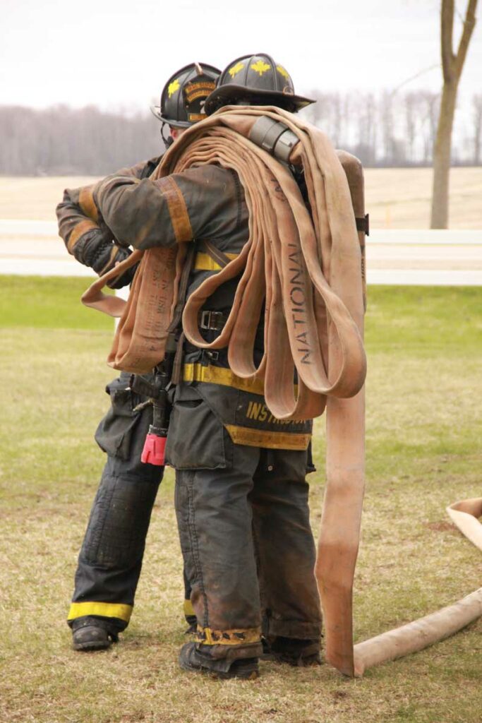 Firefighter carrying hoseline