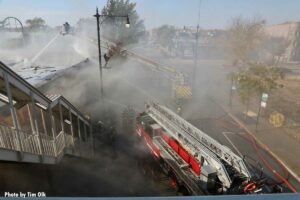 View of Chicago aerial ladder and tower ladder at fire scene