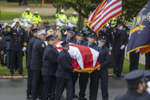 Alison Russo-Elling's casket is brought into the Tilles Center on Wednesday