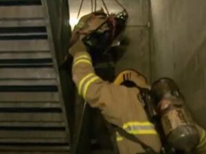 Corkscrew lowering of a down firefighter