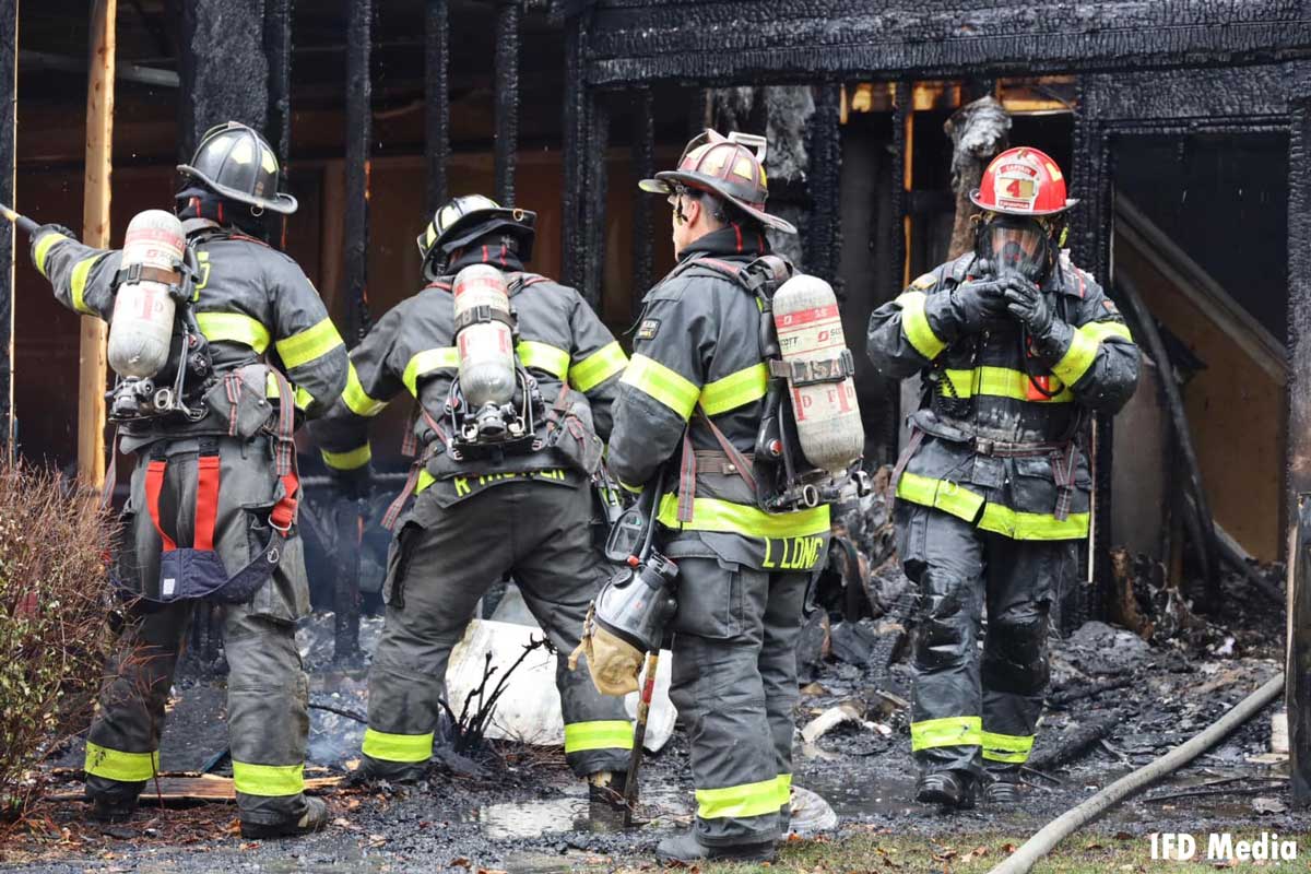 Indianapolis firefighters by charred remains of home