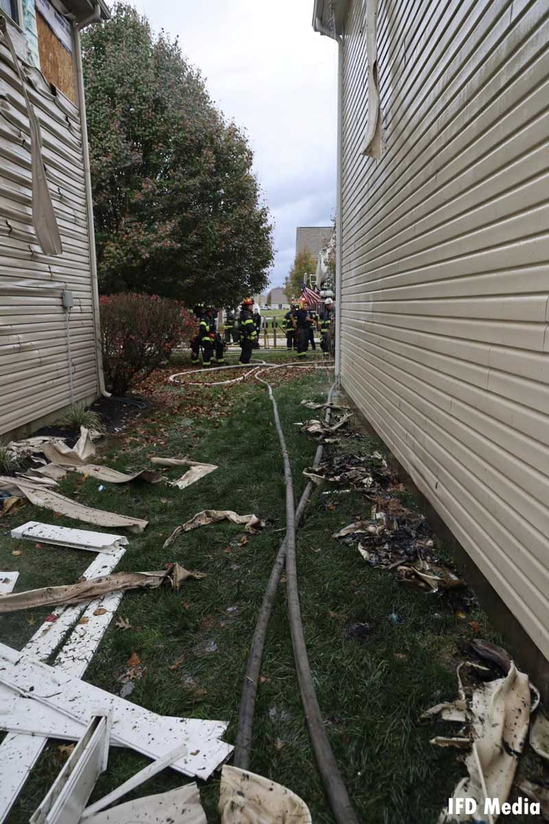 Siding from a burned home and hoselines in an alley