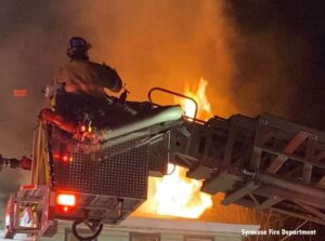 Firefighter in tower ladder bucket at Syracuse fire