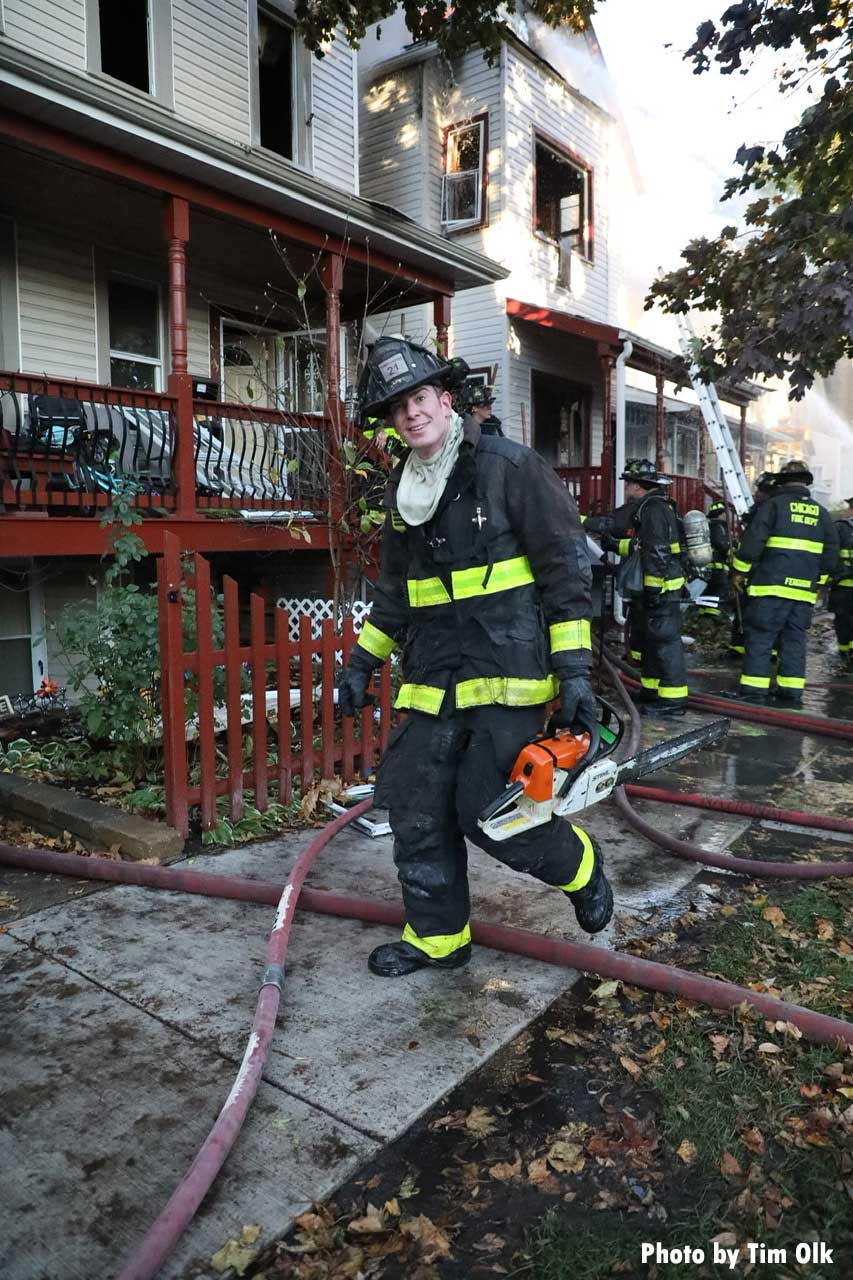 Chicago firefighter steps over hoseline