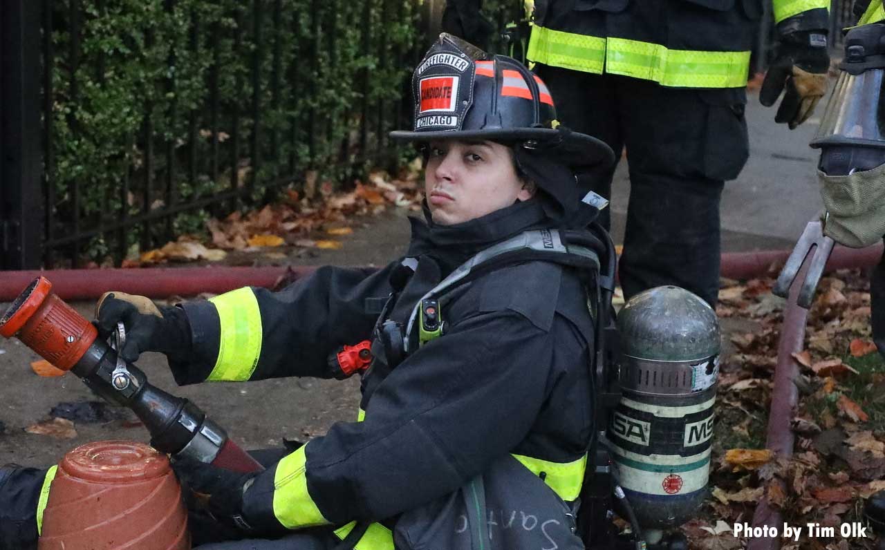 Chicago firefighter with hoseline holding nozzle