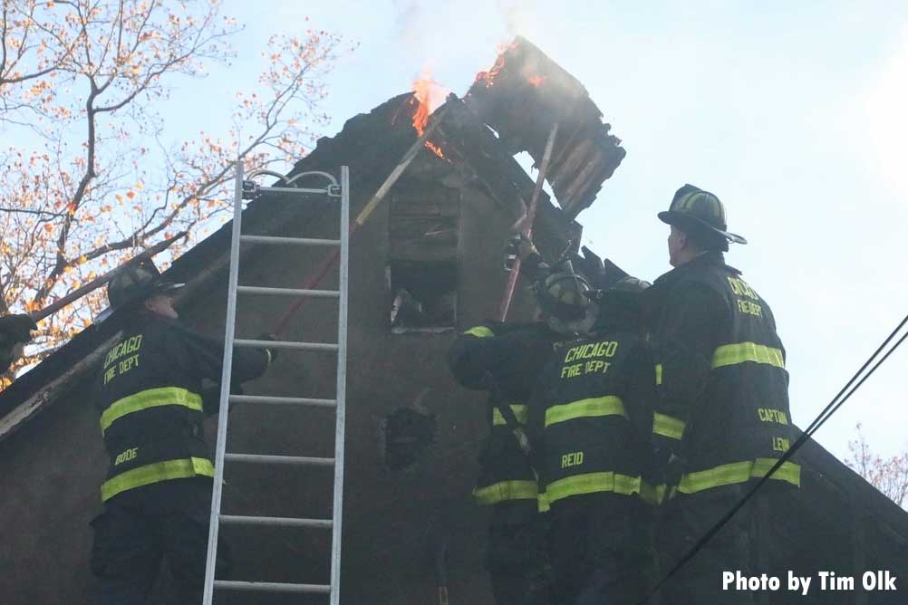 Chicago firefighters use hooks on roof