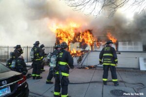 Flames vent from window covered by Vacant Property Security Systems in Chicago fire