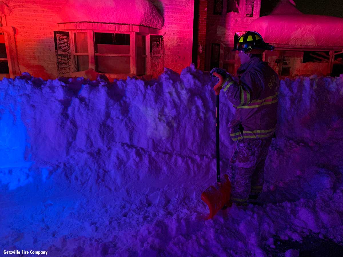 Getzville firefighter Ethan Fargo helping dig someone out of their Orchard Park home.