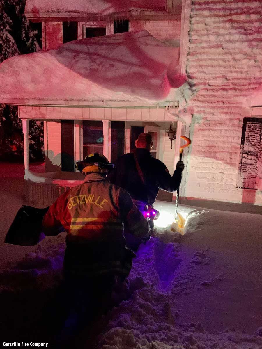 Getzville firefighters make their way through the snow to an Orchard Park resident that needed to be taken to a warming shelter.