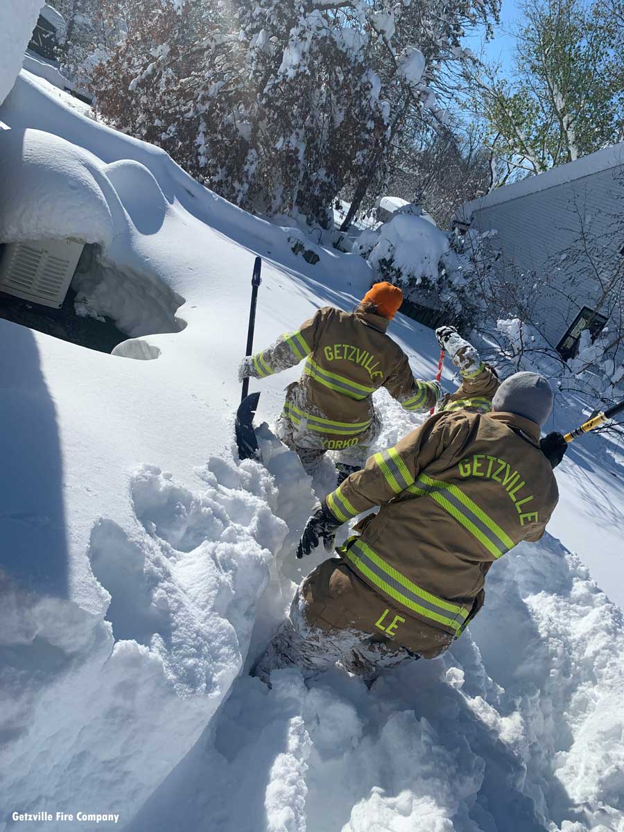 Getzville firefighters making their way through the snow to an Orchard Park home