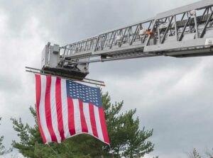 Flag on fire department tower ladder