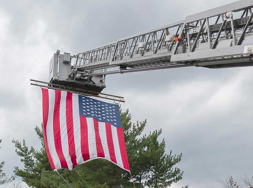 Flag on fire department tower ladder