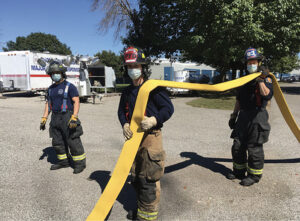 Firefighters carrying a hoseline