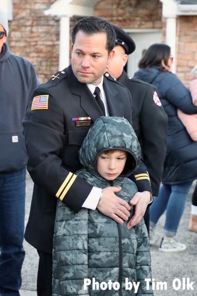 Firefighter with child during memorial