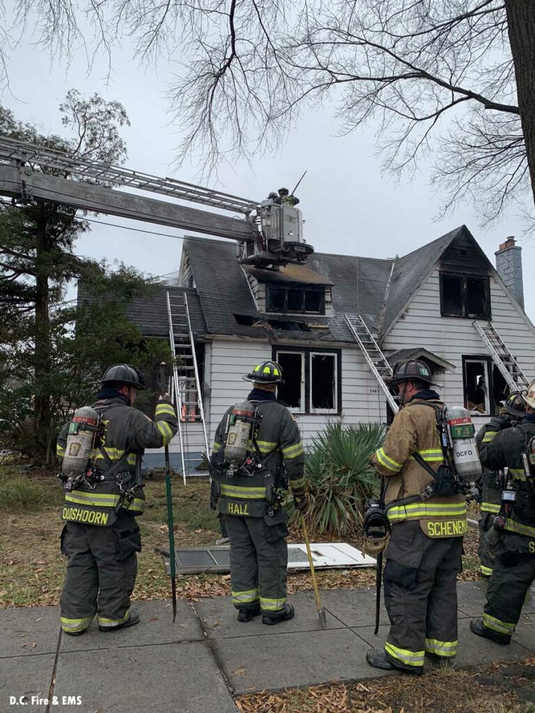 Firefighters with tools at scene of house fire in Washington D.C.