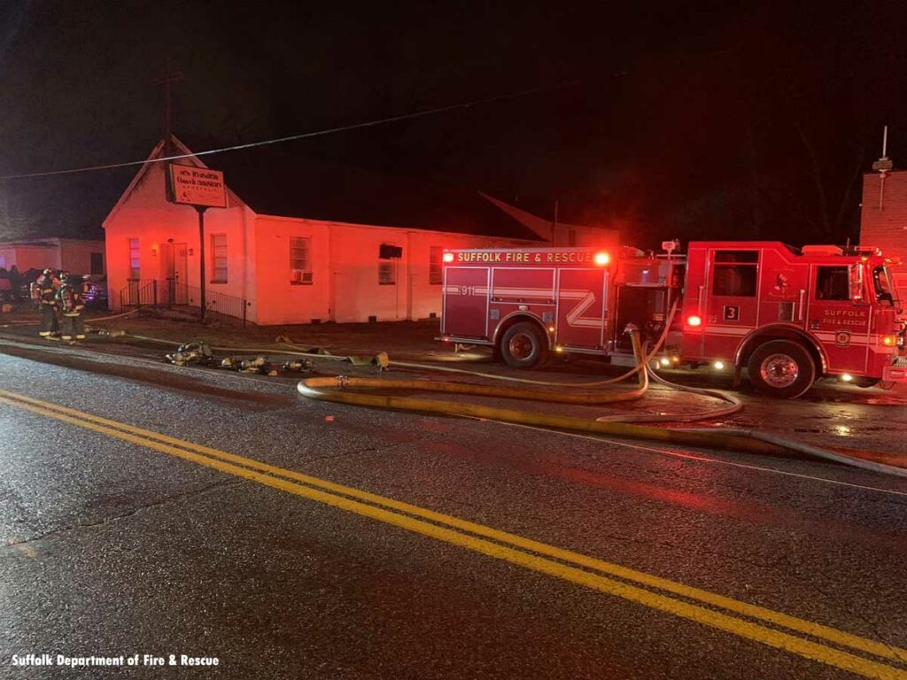 Multiple hoselines from Suffolk Fire & Rescue pumper at church fire