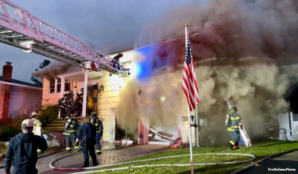 American flag with firefighters and aerial ladder at Hempstead New York fire