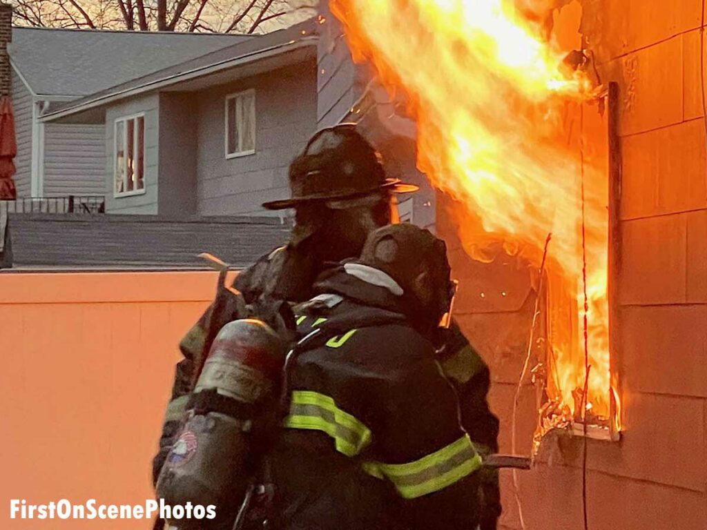 Firefighters with flames at West Hempstead house fire