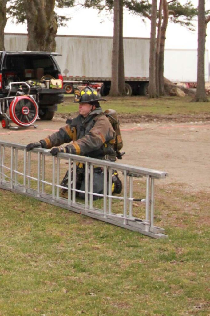 Firefighter with ground ladder