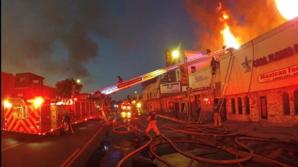 Stocktong firefighters fighting fire in commercial strip