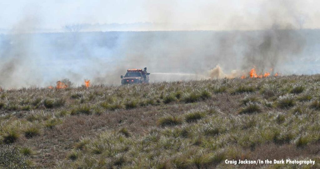 Firefighter puts water on Lake County brush fire