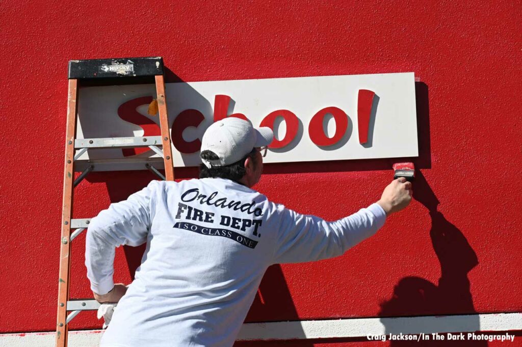 Orlando fire department volunteers paint at Children’s Safety Village