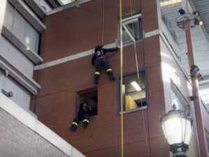 Mike Ciampo Firefighter on a rope being lowered during training