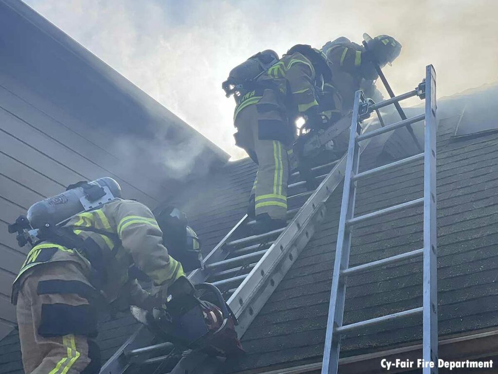 Firefighters ascending a ladder