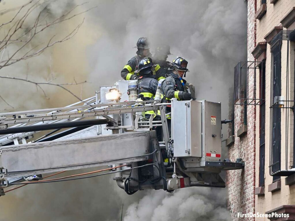 FDNY firefighters operating from tower ladder buckets at Brooklyn fire