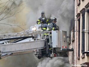 FDNY firefighters operating from tower ladder buckets at Brooklyn fire