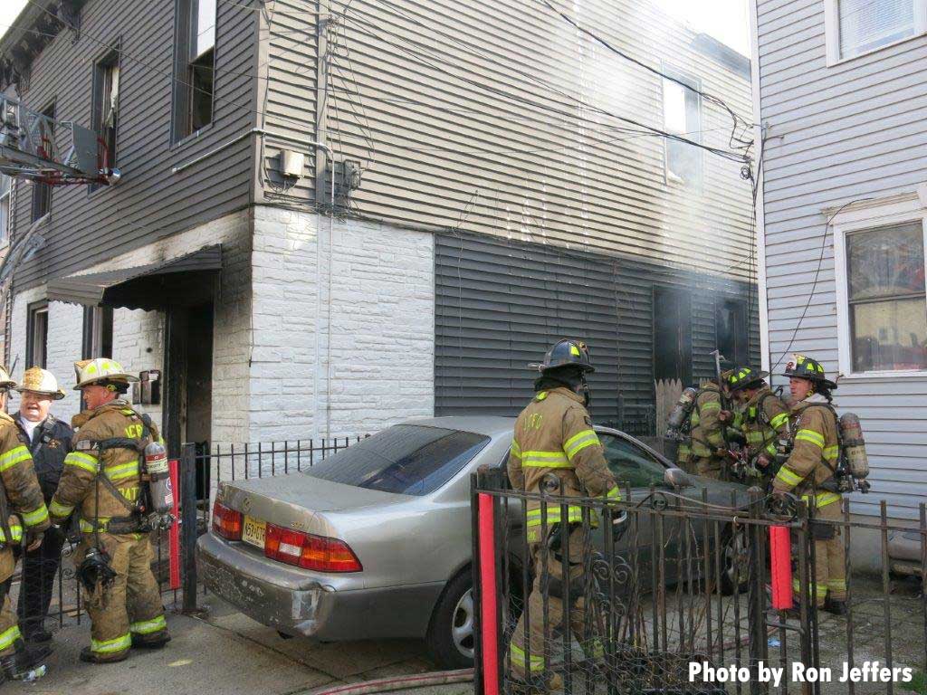 Firefighters responding to a three-alarm fire in Jersey City New Jersey