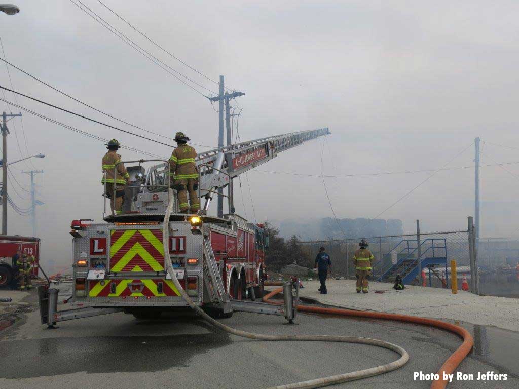 Firefighters on aerial turntable at Jersey City fire