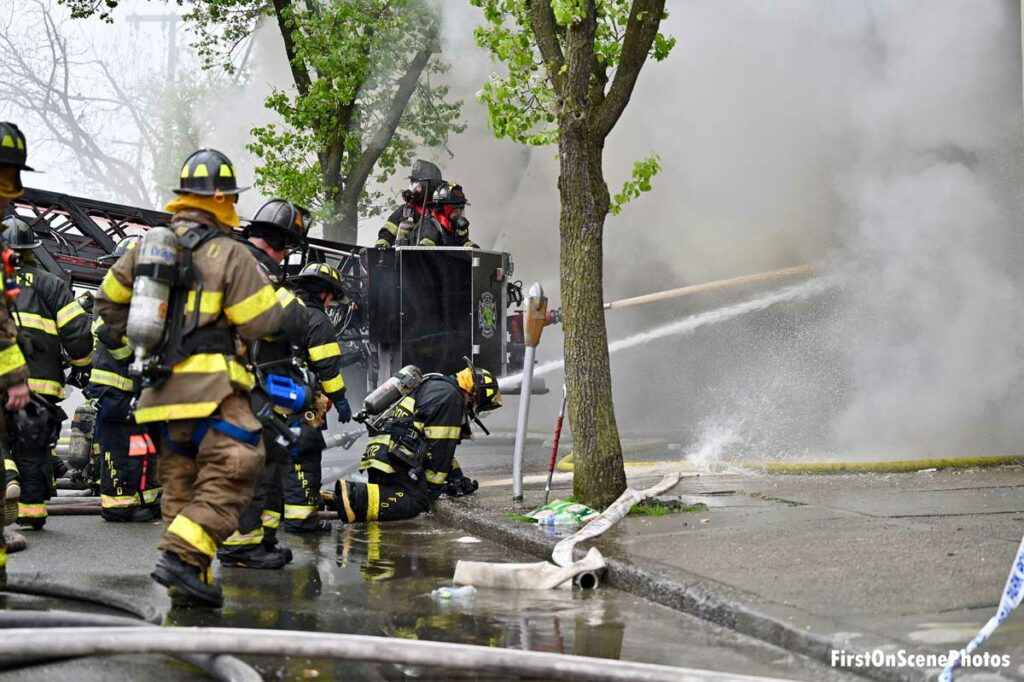 Multiple hose streams plus one from tower ladder bucket at Floral Park fire