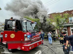 New Hyde Park fire truck with smoke at structure fire