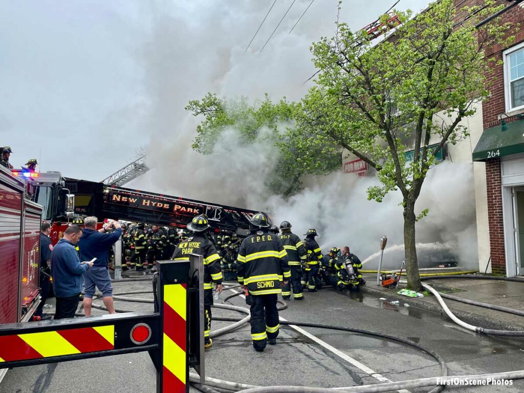 Long Island firefighters and apparatus at fire in mixed-use building