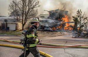 Firefighter with house on fire