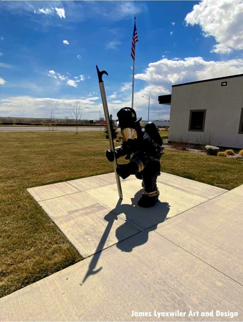 American flag and firefighter statue