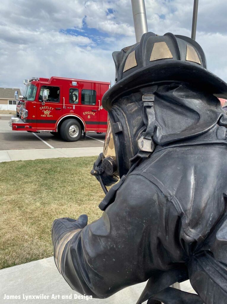 Greeley fire truck with firefighter statue