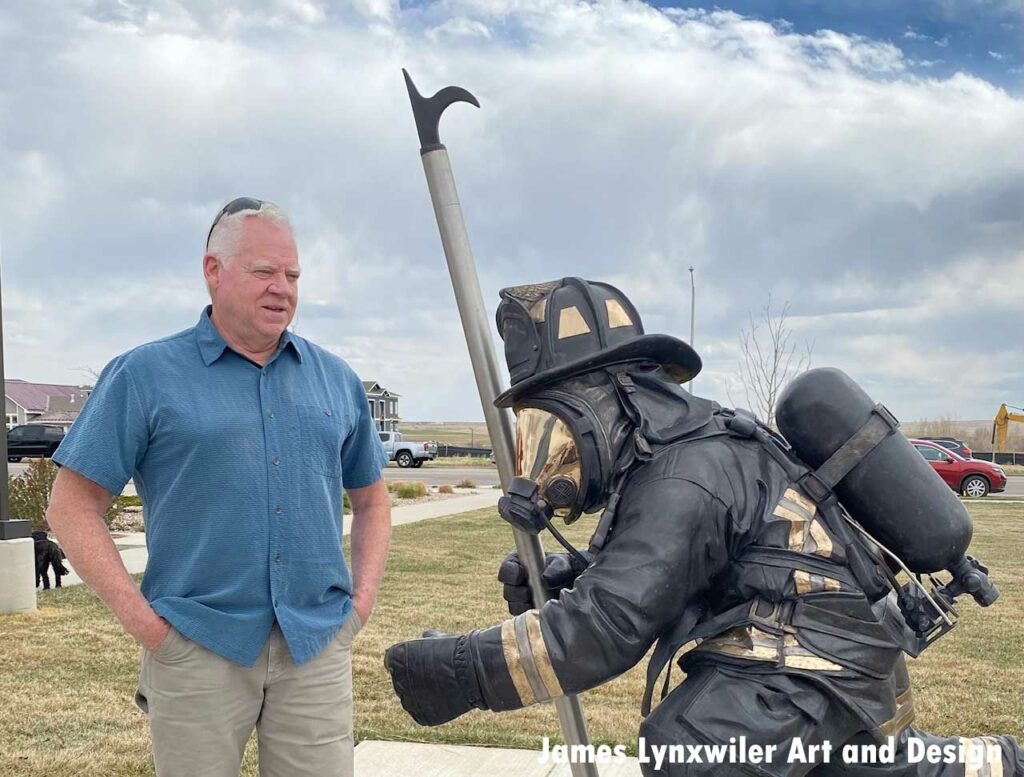 Sculptor with firefighter statue