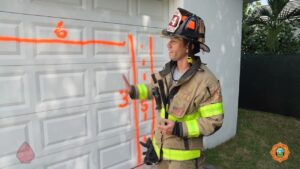 MDFR firefighter trianing on residential garage door forcible entry