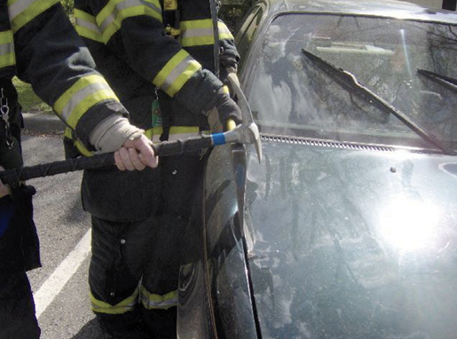 Insert ax between fender and hood