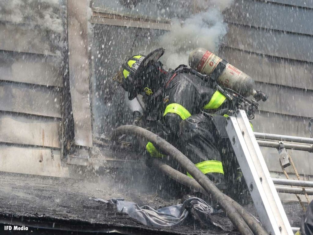 Indianapolis firefighter going through the window