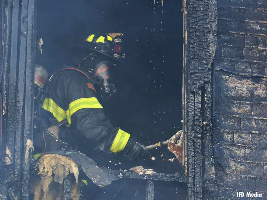 Firefighter peforming overhaul