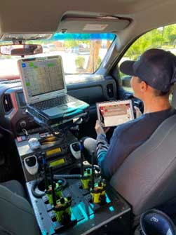 Officer completing the Fire Post Incident Analysis form in command vehicle