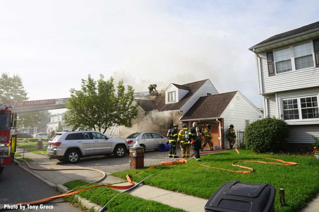 Firefighter ascends aerial to roof at Rochelle Park fire