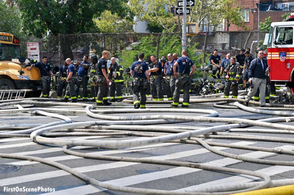 Firefighters and hoselines in streets of Brooklyn